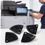 Cassette de levage engrenage Samsung JC66-03278A imprimée en 3D devant une imprimante MultiXpress