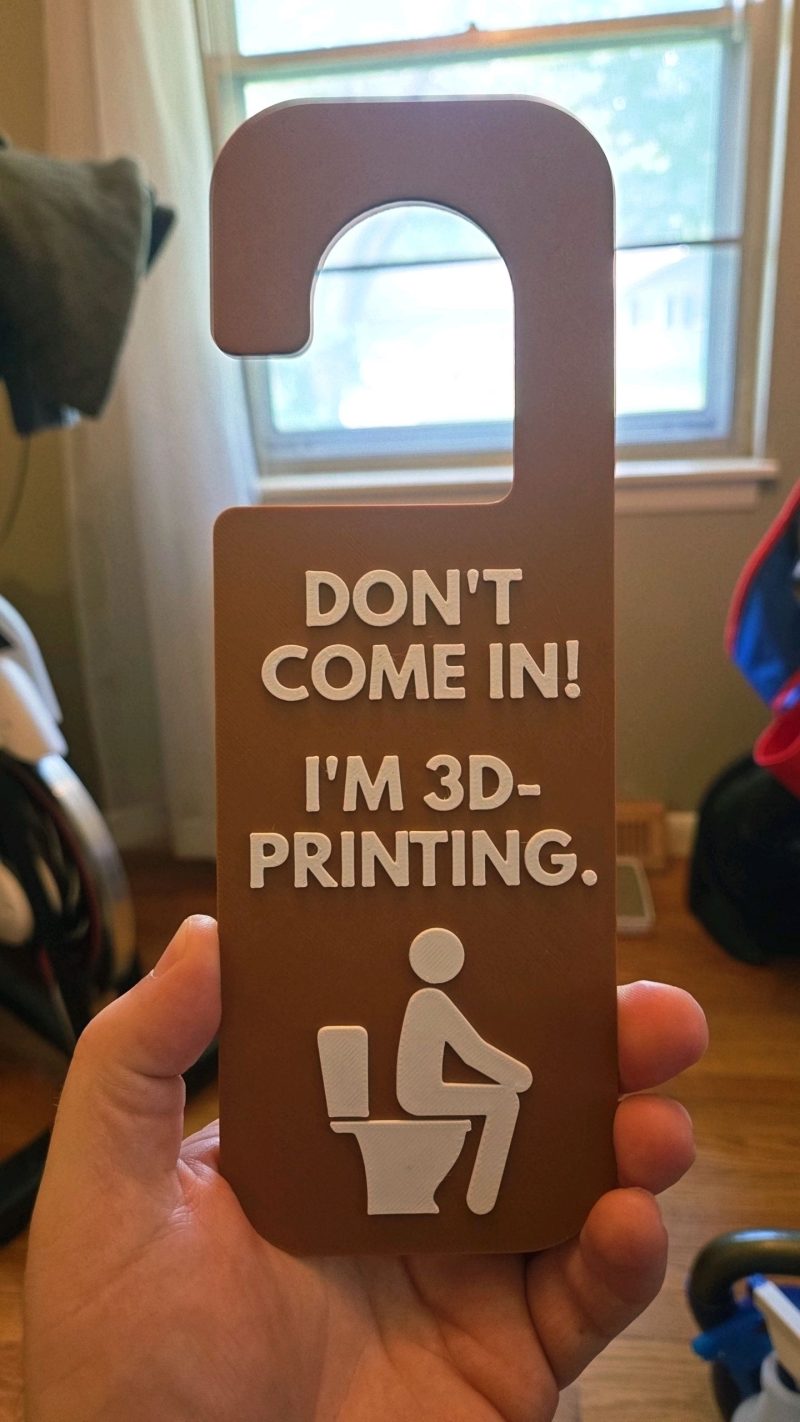 Plaque de porte pour toilettes — version qui fait sourire