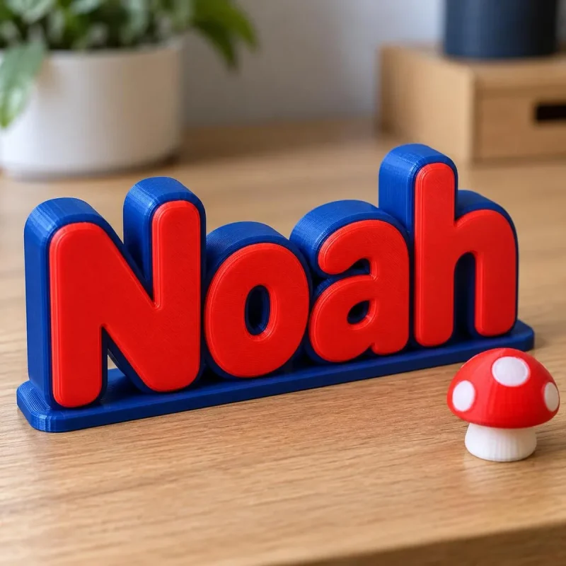 Prénom 3D Mario vu de près, lettres bicolores imprimées en 3D, avec un accessoire (champignon) en option
